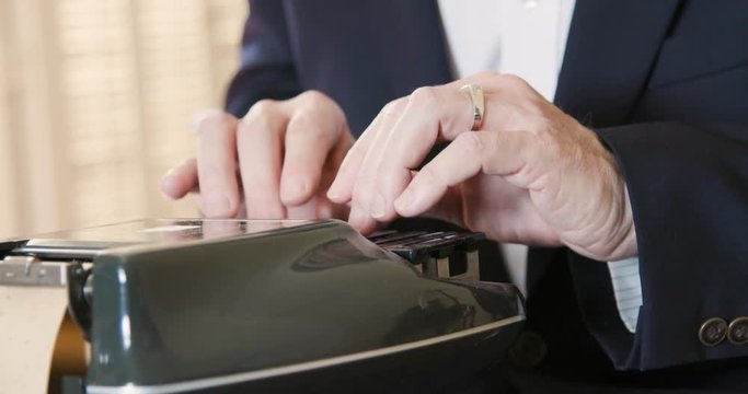 Stenographer or court reporter typing out short hand using a stenograph or steno writer machine.