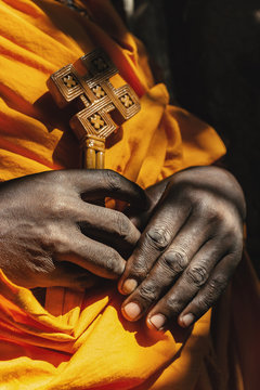 An Ethiopian monk holds a wooden cross.