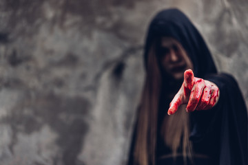 Portrait woman ghost devil she has point finger out and hand have red blood