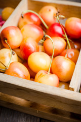 Ripe cherries in wooden crate. Selective focus. Shallow depth of field.