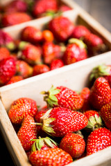 Ripe strawberry in wooden crate. Selective focus. Shallow depth of field.