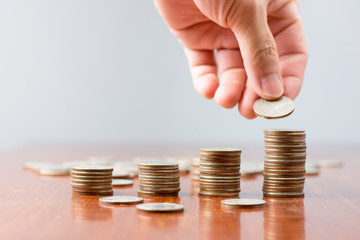 Close up hand sort the coins on the table..