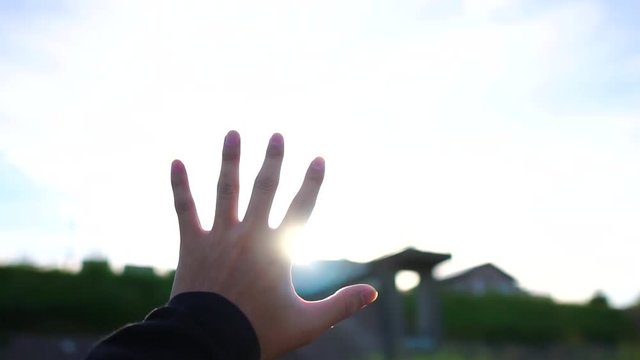 Male hands and sunset