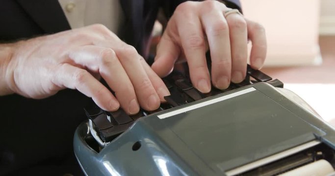 Stenographer or court reporter typing out short hand using a stenograph or steno writer machine.