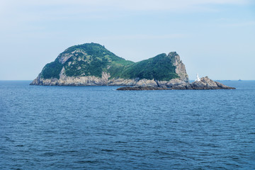 Fototapeta na wymiar Island Hoenggando-gil with white lighthouse seen from ferry from Jeju to Mokpo, South Korea