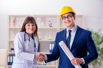 Doctor discussing new hospital plan with architect