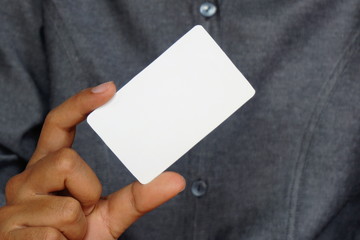 Man holding white business card