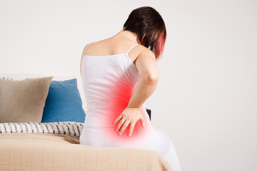 Back pain, kidney inflammation, woman suffering from backache at home