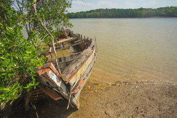 Naklejka na ściany i meble Old wooden boat sunk near the river in Krabi province Thailand