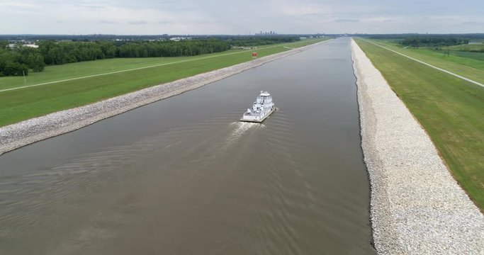 A long tow is running under a highway bridge on the Chain of Rocks Canal above St Louis, aerial view