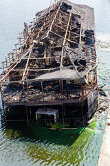 Burned ship in the water