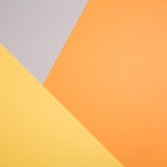 geometric paper background in autumn tones. corners and triangles of gray, yellow, orange colors.