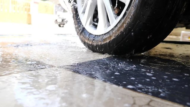 slow motion, water spraying car wash cleaning wheels