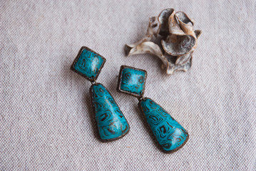 Handmade turquoise earrings from polymer clay. Indian design. Boho jewelry.Fashion background.