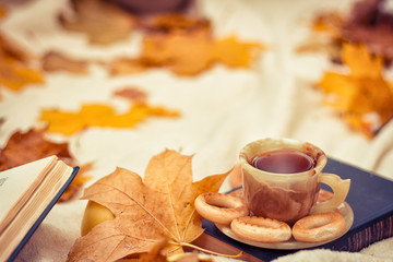 Naklejka na ściany i meble a cup of hot tea with pastries at a picnic in the autumn forest