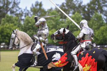 Two medieval knights confront during jousting tournament