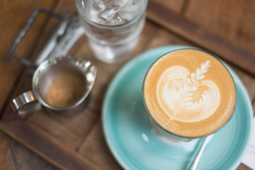 Selective  focus of latte art on wooden table , background