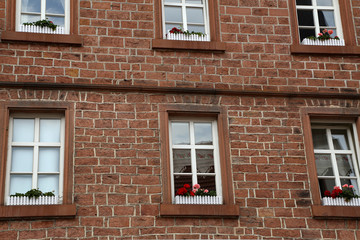 Fototapeta na wymiar Brick wall of a house with windows
