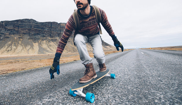Skater traveling iceland on his longboard