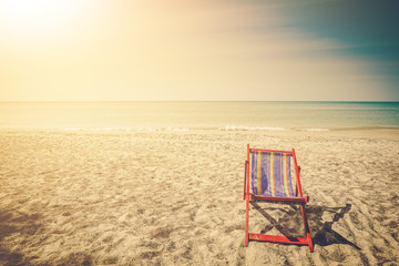 Fototapeta na wymiar A portrait of a pair of beach chair with umbrella in a seashore