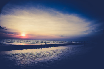 Obraz premium Nature in twilight period which including of sunrise over the sea and the nice beach. Summer beach with blue water and purple sky at the sunset.