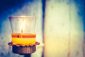Colorful Candles light for Christmas candles burning at night. Abstract candles background. Golden light of candle flame with vintage retro tone.
