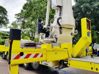 Firefighter rescue training people in hight-rise building to escape by using  extended ladder crane of fire truck. Fire drills and training concept.