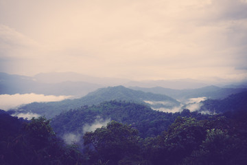 Obraz premium Scenic view of sunrise mountains at northeast Thailand, Mountain range for climbing in mountain trails. the landscape of mountain which including of copy-space for texting. - Vintage retro tone.