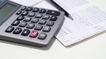 calculator and book bank on table