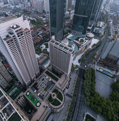 Fototapeta premium Aerial View of business area and cityscape in foggy dawn, West Nanjing road, Jing`an district, Shanghai
