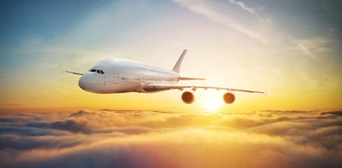 Naklejka premium Huge two-storey passengers airplane flying above clouds