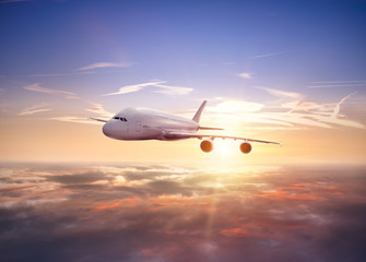 Fototapeta na wymiar Huge two-storey passengers airplane flying above clouds