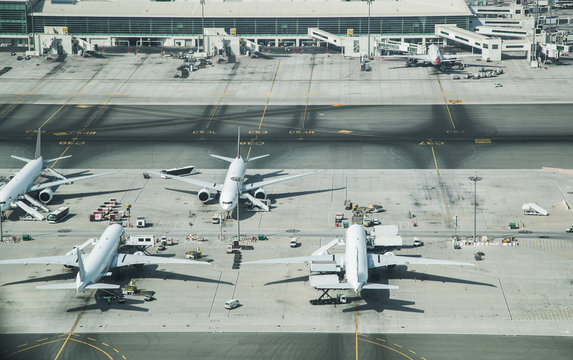 Aerial view of parked airplanes in the airport terminal.