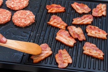 Meat on an electric grill. Home cooking. Healthy barbecue. Catering to friends. Electric grilling.