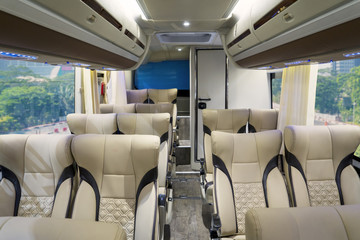 Luxury bus interior with comfortable seats © Creativa Images