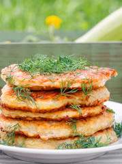 Delicious pancakes from courgettes and fresh vegetables with sour cream and dill