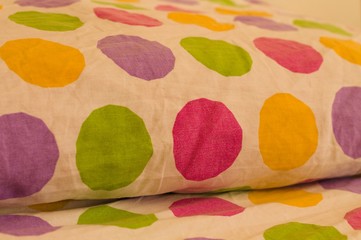 Bed and pillow with colored pois (Pesaro, Italy, Europe)