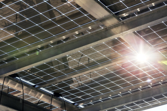 Partially transparent glass modules on carport