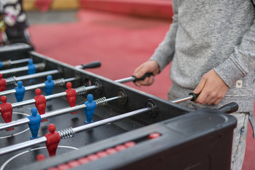 young man playing tablefootball in park in moscow
