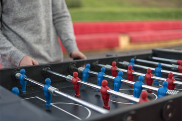 young man playing tablefootball in park in moscow