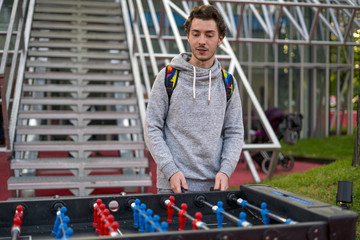 young man playing tablefootball in park in moscow