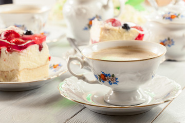 Cup of coffee served with cheesecake