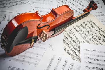 the violin lies on scattered notes