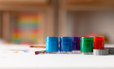 Opened bottles of poster color and brush