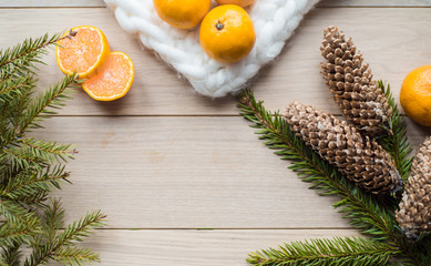 New Year Concept. Christmas decorations from fir-tree branches and the fruits of mandarin orange on background.