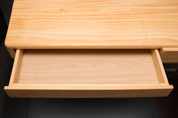 Naklejka na ściany i meble An empty wooden drawer isolated on black background