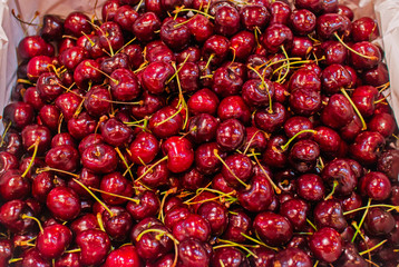 Background of fresh organic red cherries in basket on supermarket, Healthy food concept.