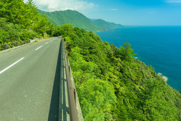 Obraz premium Empty road along the coast on an island.