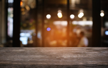 Empty dark wooden table in front of abstract blurred bokeh background of restaurant . can be used for display or montage your products.Mock up for space.