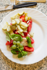 Tomato, gherkins, basil & grapes salad with vinaigrette dressing 
